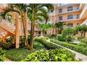 Lush courtyard featuring mature landscaping, garden spaces and stone paths at 1613 Gondola Park Dr # 1613, Venice, FL 34292