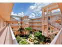 Well maintained courtyard surrounded by multistory condos, stairways and walkways at 1613 Gondola Park Dr # 1613, Venice, FL 34292