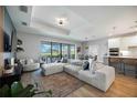 Spacious living room with a large sliding glass door to the patio and a dining area nearby at 16418 Slate Pl, Lakewood Ranch, FL 34211