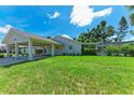 Spacious backyard featuring a well-maintained lawn and ample space for outdoor activities at 2400 Lake Shore Dr, Nokomis, FL 34275