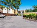 Apartment building featuring well-maintained landscaping and convenient parking at 2748 Orchid Oaks Dr # 202, Sarasota, FL 34239