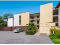 Well-lit exterior shot of the apartment complex showing lush landscaping and convenient parking at 2748 Orchid Oaks Dr # 202, Sarasota, FL 34239