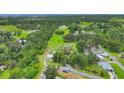 Large lot featuring lush landscaping and a cozy home, offering a serene retreat and ample space for outdoor activities at 3511 39Th E St, Palmetto, FL 34221
