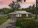 Inviting single-story home featuring a well-manicured lawn, complemented by a serene twilight backdrop at 4023 Hina Dr, Sarasota, FL 34241