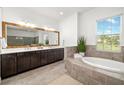 Spacious bathroom featuring a soaking tub and double vanity sinks at 408 166Th E St, Bradenton, FL 34212