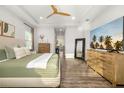 Bright main bedroom with modern decor and a hallway leading to the bathroom at 408 166Th E St, Bradenton, FL 34212