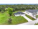 Aerial view of home features a large yard and nearby wooded area at 4148 Lobelia St, North Port, FL 34286