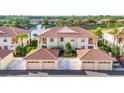 Beautiful exterior view of condo, showcasing tiled roofs, attached garages and manicured landscaping at 4210 Vicenza Dr # D25, Venice, FL 34293