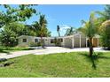 Inviting single-story home featuring lush landscaping, driveway and carport at 4214 Groveland Ave, Sarasota, FL 34231