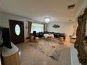 Elegant living room showcasing stylish seating, an ornate mirror, and a view of the entryway at 4337 15Th N Ave, St Petersburg, FL 33713