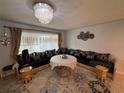 Bright living room with chandelier, custom seating arrangement, and large window at 4337 15Th N Ave, St Petersburg, FL 33713