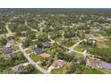 A picturesque aerial view showcases a quiet neighborhood with lush, green trees at 4357 Mermell Cir, North Port, FL 34291