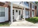 Apartment entrance featuring a white door and columns with white shutters and potted plants at 4507 9Th W St # J11, Bradenton, FL 34207