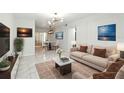 Bright living room with marble floors, a modern chandelier, and contemporary furnishings at 4507 9Th W St # J11, Bradenton, FL 34207
