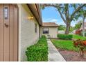 Home exterior featuring manicured hedges, stucco siding, and warm exterior lighting at 495 Oak Hill Cir # 44, Sarasota, FL 34232