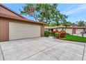 The front exterior features a wide driveway leading to an attached two-car garage, and a well-maintained lawn at 495 Oak Hill Cir # 44, Sarasota, FL 34232