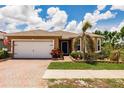 Single-story home with a manicured lawn and vibrant landscaping at 5301 Shell Mound Cir, Punta Gorda, FL 33982