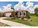 Landscaped front yard of home with lawn and plantings at 5301 Shell Mound Cir, Punta Gorda, FL 33982