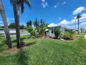 Beautiful home with lush landscaping including palm and banana trees at 5402 Chateau Ln, Bradenton, FL 34207