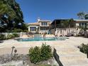 Resort-style pool with lush landscaping, a waterfall feature, and a spacious deck, perfect for entertaining at 624 Mourning Dove Dr, Sarasota, FL 34236