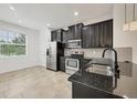 Modern kitchen featuring stainless steel appliances and dark cabinets at 6454 Baytown Dr, Sarasota, FL 34240