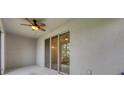 Covered patio with ceiling fan and sliding glass doors at 6454 Baytown Dr, Sarasota, FL 34240