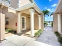 Front entrance with white columns, a white door, and manicured landscaping in a well-maintained community at 6604 7Th Avenue W Cir, Bradenton, FL 34209