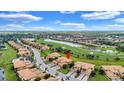Beautiful aerial view of community homes overlooking the lush golf course and scenic water features at 6918 Grand Estuary Trl # 104, Bradenton, FL 34212