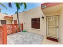 Exterior of unit 814 featuring a charming courtyard entrance with pavers, lattice, and desert landscaping at 814 Spring Lakes Blvd # 14, Bradenton, FL 34210