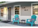 Inviting front porch with blue Adirondack chairs and charming decor at 946 Charlotte Ave, Sarasota, FL 34237