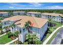 Beautiful condo showcasing a beige exterior, tile roof, and lush landscaping in a serene community setting at 1000 San Lino Cir # 1034, Venice, FL 34292