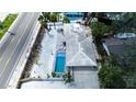 Aerial view of single-story home with a pool, shell yard, and convenient access to the beach at 1201 Big Oak Ln, Sarasota, FL 34242