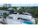 Expansive aerial view of a single-story home with a swimming pool, patio, and manicured landscaping at 1201 Big Oak Ln, Sarasota, FL 34242