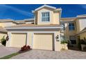 Inviting two-story townhome boasts a well-manicured lawn and charming two-car garage at 1251 Burgos Dr # 303, Sarasota, FL 34238