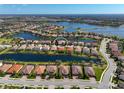 Stunning aerial view of the community featuring a lake, and lovely homes in a desirable neighborhood at 13026 Ramblewood Trl, Bradenton, FL 34211