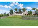 Stone monument sign for Esplanade Golf and Country Club with lush landscaping on a sunny day at 13714 Messina Loop # 202, Bradenton, FL 34211