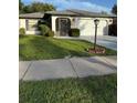 Charming single-story home with a well-kept lawn, attached garage, and stylish exterior lighting at 1725 Briar Creek Ln, Sarasota, FL 34235