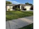 Single story home featuring manicured lawn and a two car garage, providing ample curb appeal at 1725 Briar Creek Ln, Sarasota, FL 34235