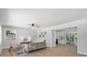 Bright living room with neutral tones, wood flooring and lots of natural light creating a relaxing atmosphere at 1857 Siesta Dr, Sarasota, FL 34239
