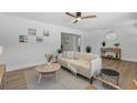 Cozy living room featuring natural light, a comfortable sofa and a stylish decorative arrangement at 1857 Siesta Dr, Sarasota, FL 34239