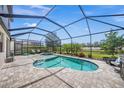 Relaxing screened-in pool area with lush greenery and a hot tub, perfect for outdoor entertaining at 19369 Nearpoint Dr, Venice, FL 34292