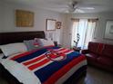 Bedroom featuring a large bed, side tables, and bright window with decorative curtains at 2411 Quail Ct, Bradenton, FL 34209