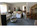 Bright living room with neutral carpeting, comfortable seating, and a doorway leading to other rooms at 2617 Riverbluff Pkwy # V151, Sarasota, FL 34231