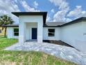 Modern home featuring a covered entryway, a paver walkway and minimalist landscaping at 2692 Pretzel Ln, North Port, FL 34286