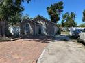 Exterior view of the home showcases a brick driveway and well-maintained landscaping at 2804 11Th Street E Ct, Bradenton, FL 34208