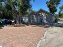 Exterior view of the home showcases a brick driveway and well-maintained landscaping at 2804 11Th Street E Ct, Bradenton, FL 34208