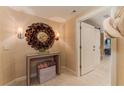 Inviting hallway with decorative mirror, table, and a barn door, enhancing the home's charm at 3401 54Th W Dr # 201, Bradenton, FL 34210