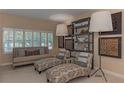 Bright and airy living room featuring stylish seating, decorative shelving, and plantation shutters at 3401 54Th W Dr # 201, Bradenton, FL 34210
