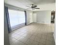 Bright living room featuring tile floors, large window, and ceiling fan at 3526 Southern W Pkwy, Bradenton, FL 34205