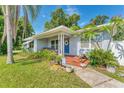 Inviting covered front porch with seating, plants, and a blue door with wreath detail at 401 N Jefferson Ave, Sarasota, FL 34237